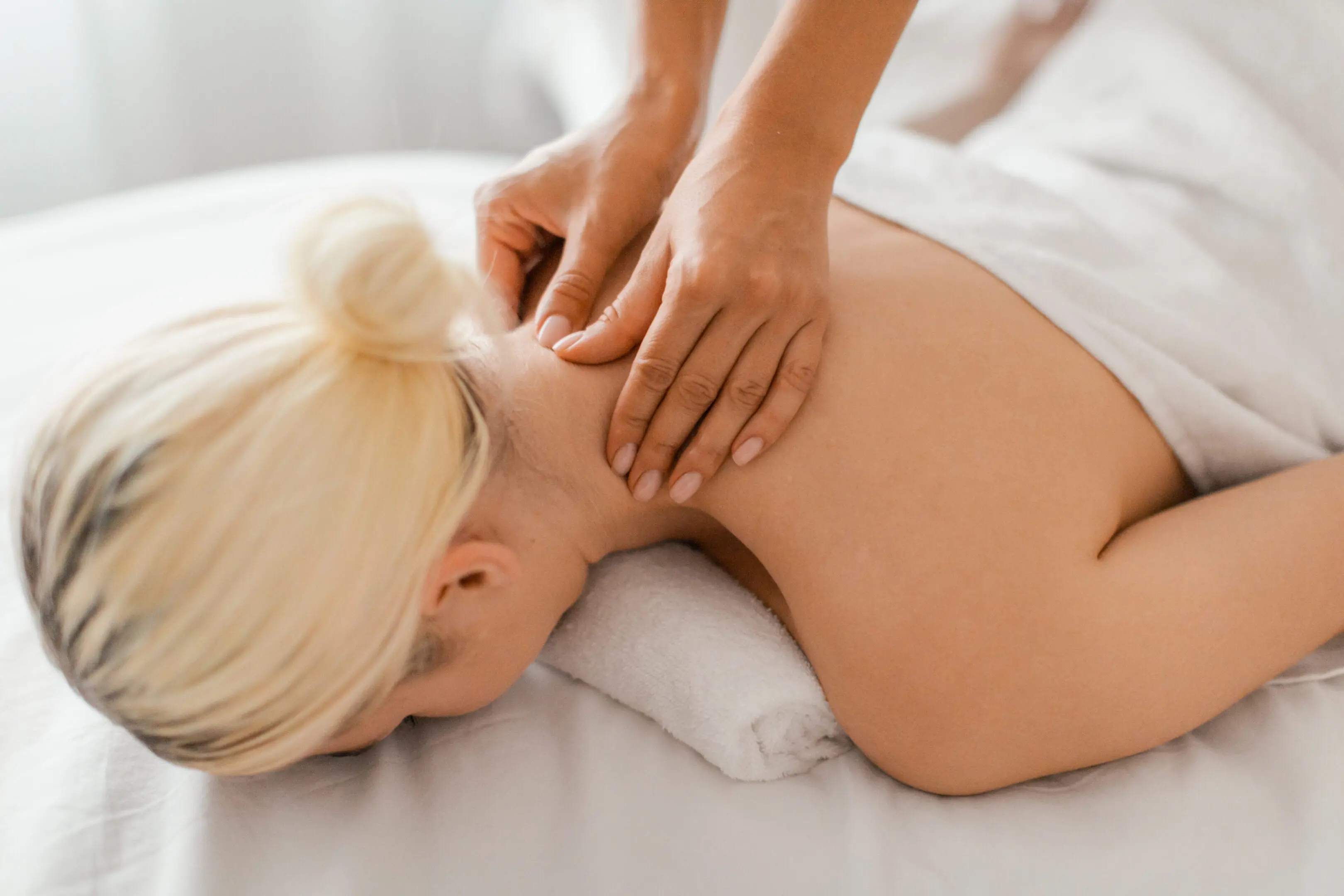 A woman getting her back massage done by someone else