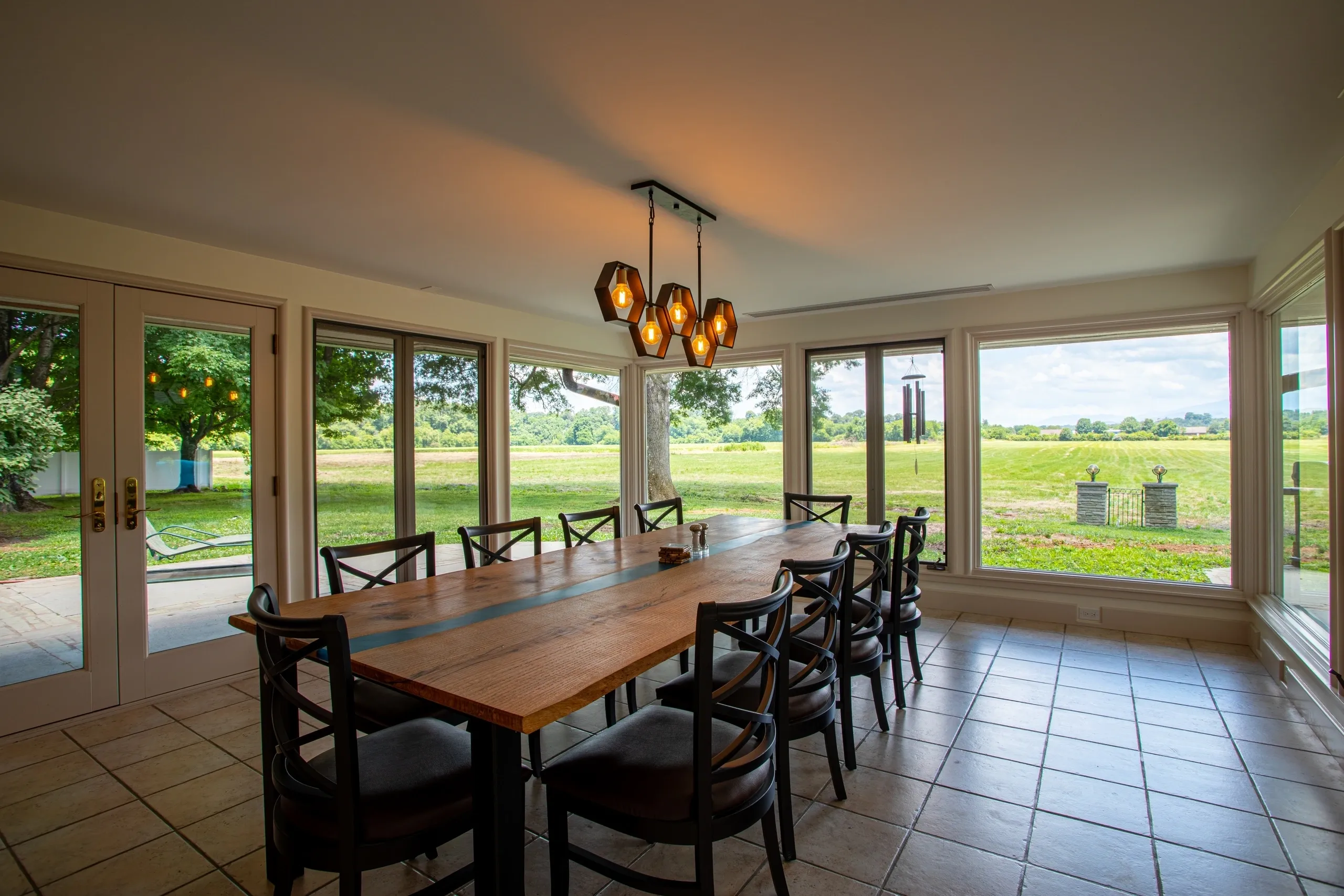Dining room with large windows and table.