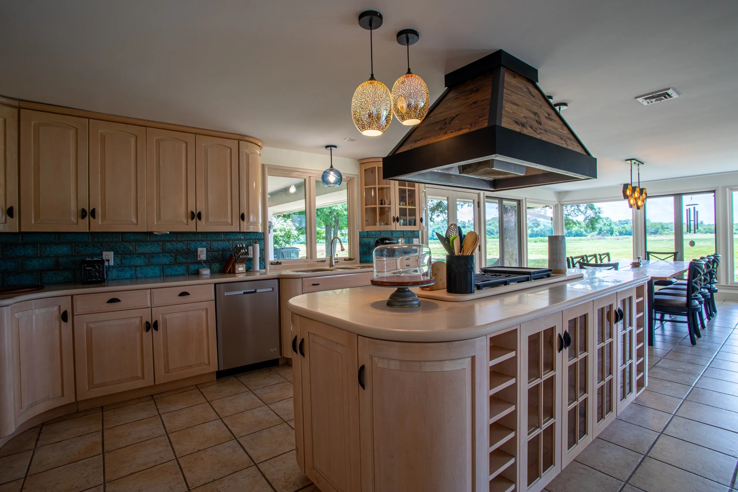 Spacious kitchen with island and pendant lights.