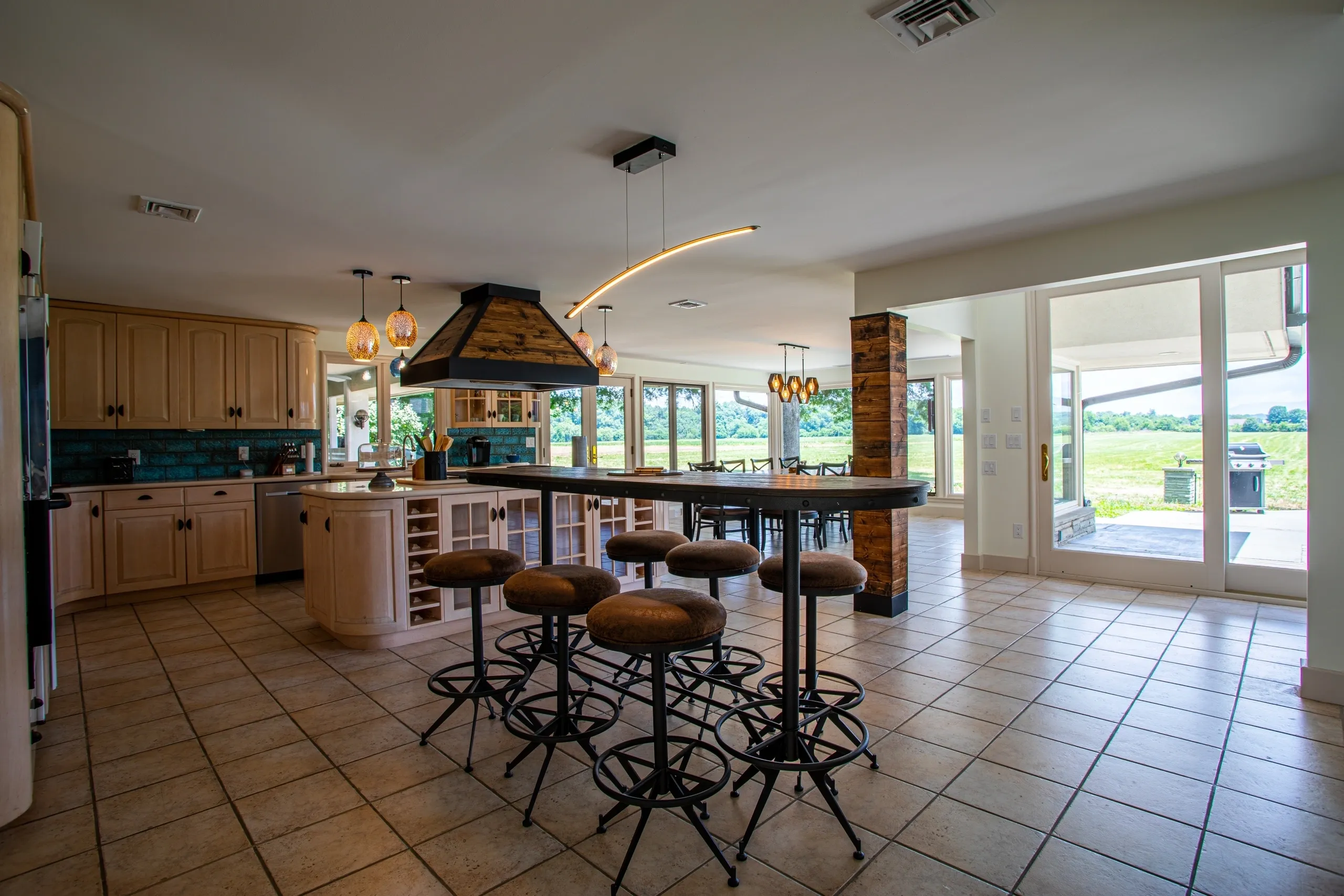 Spacious kitchen with island and bar stools.