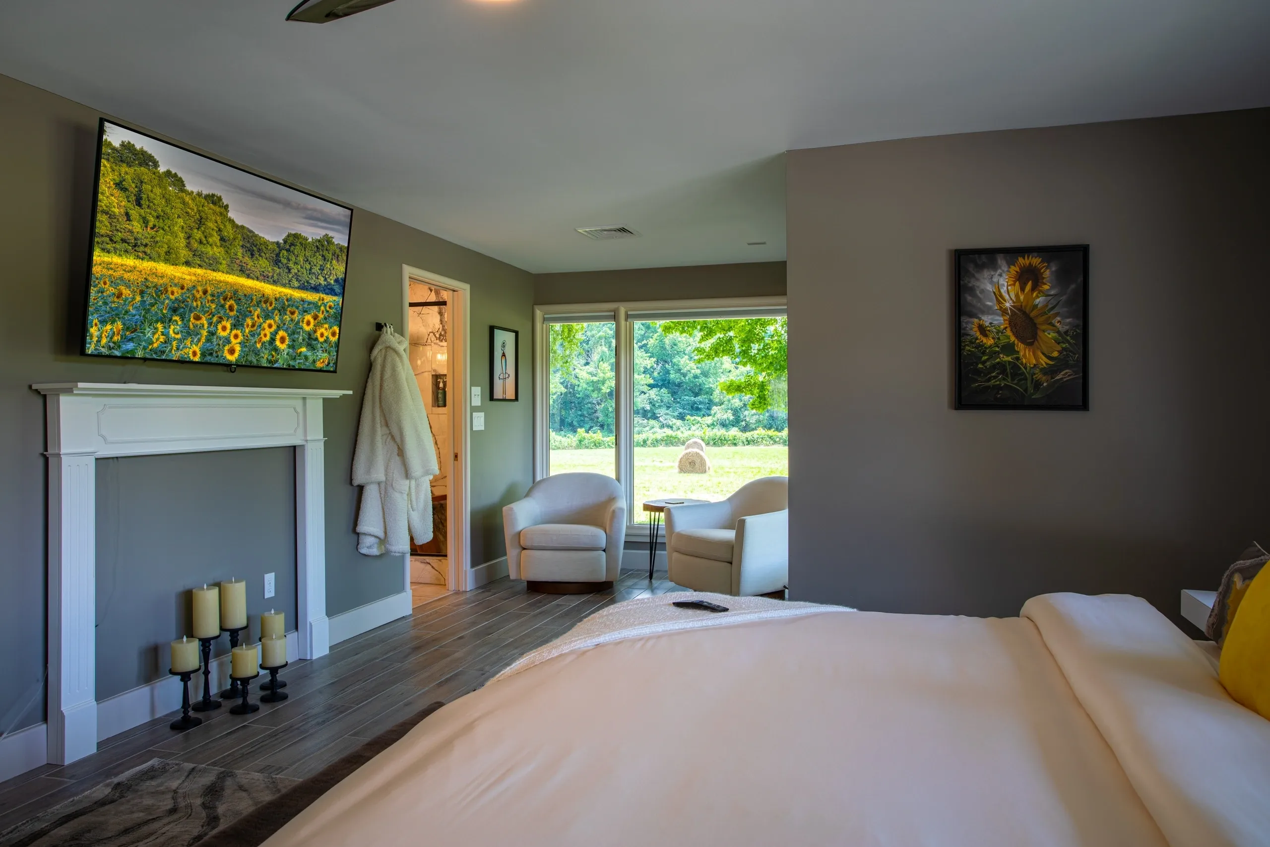 Cozy bedroom with seating and nature view.