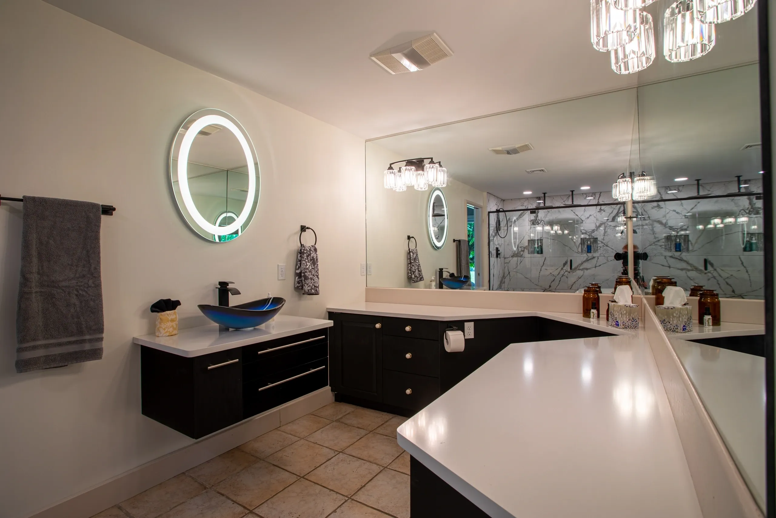 Modern bathroom with illuminated mirror and sink.