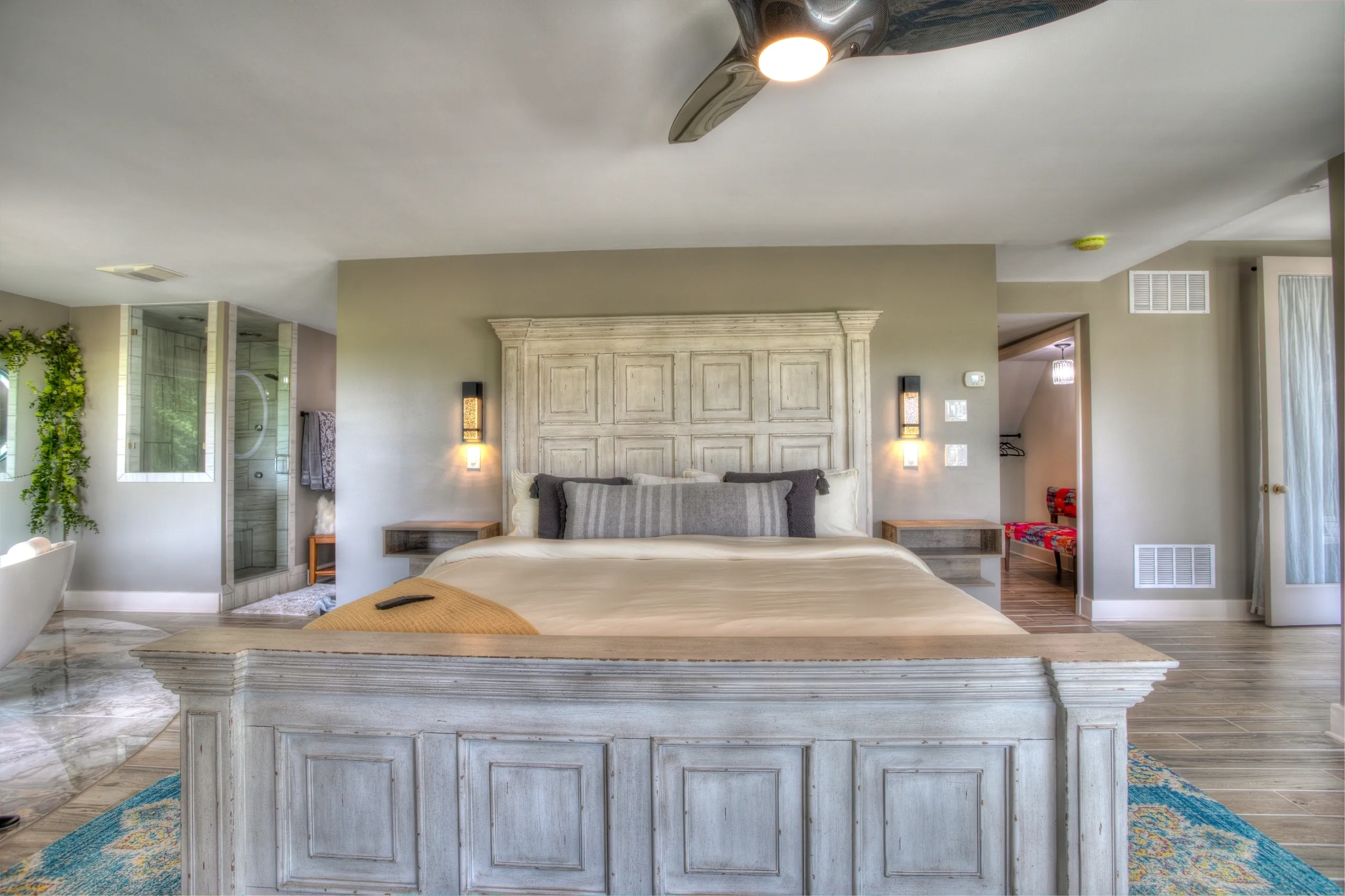 Spacious bedroom with wooden bed frame.