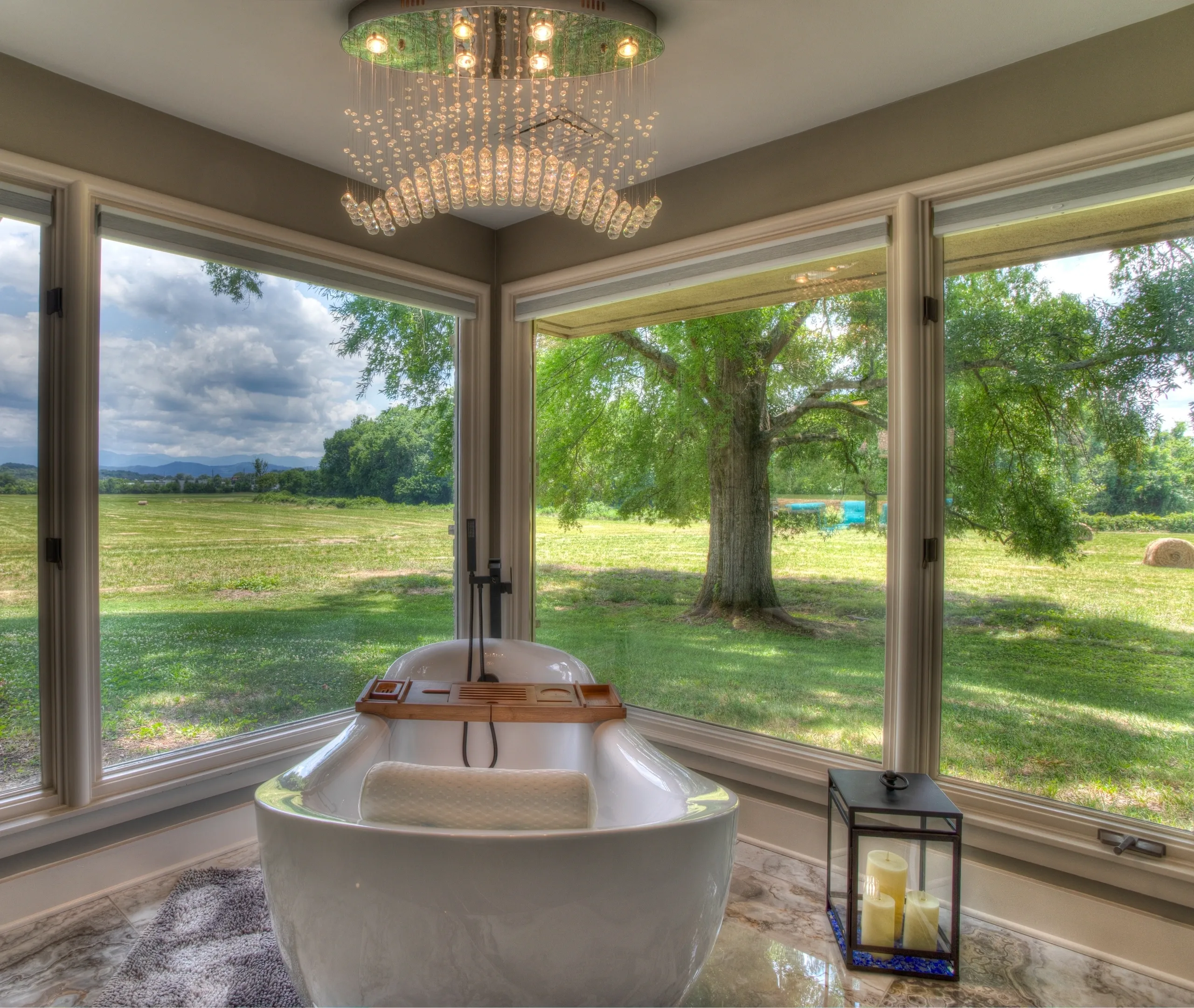 Luxurious bathroom with scenic outdoor view.