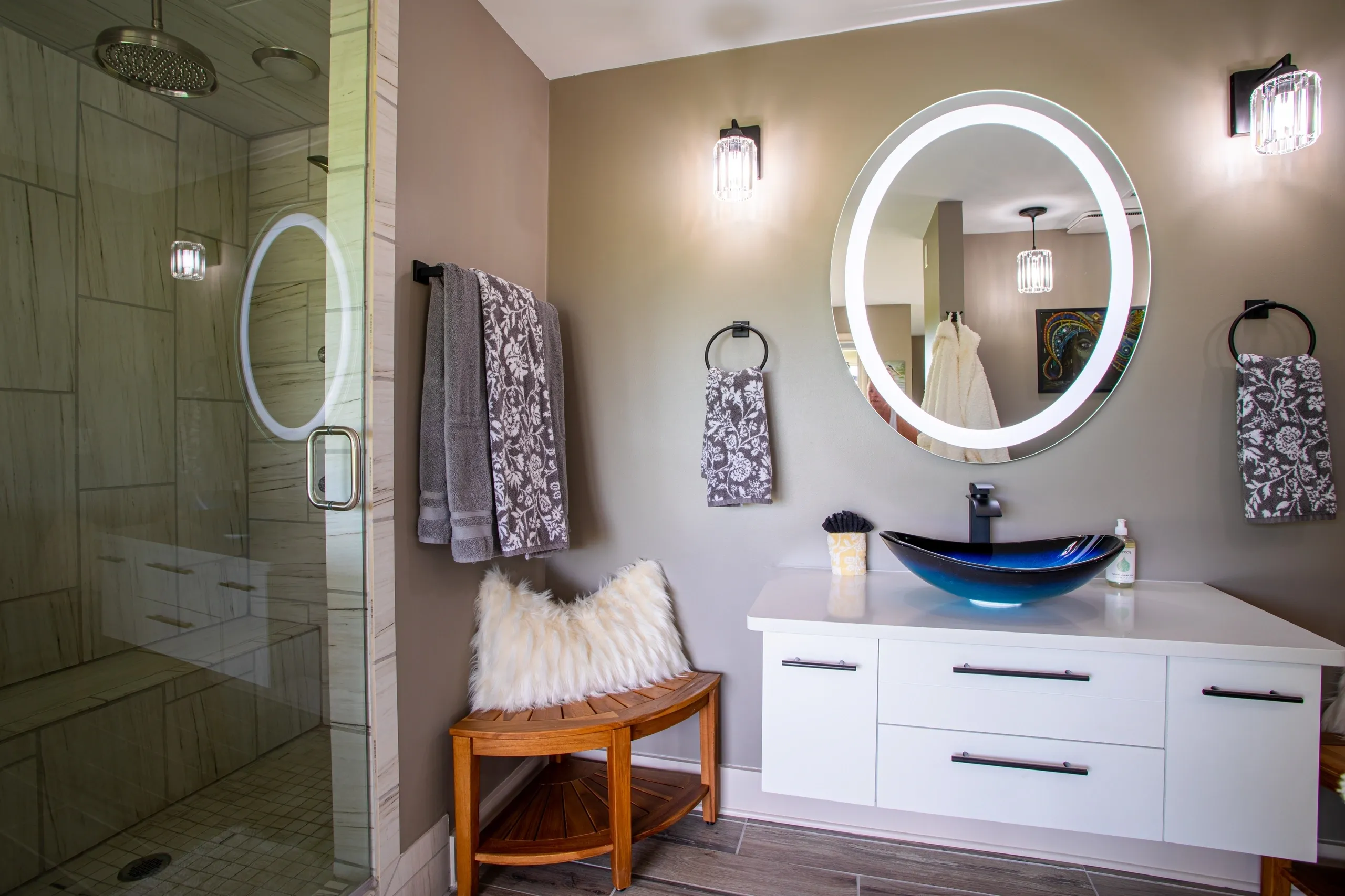 Modern bathroom with illuminated mirror and shower.