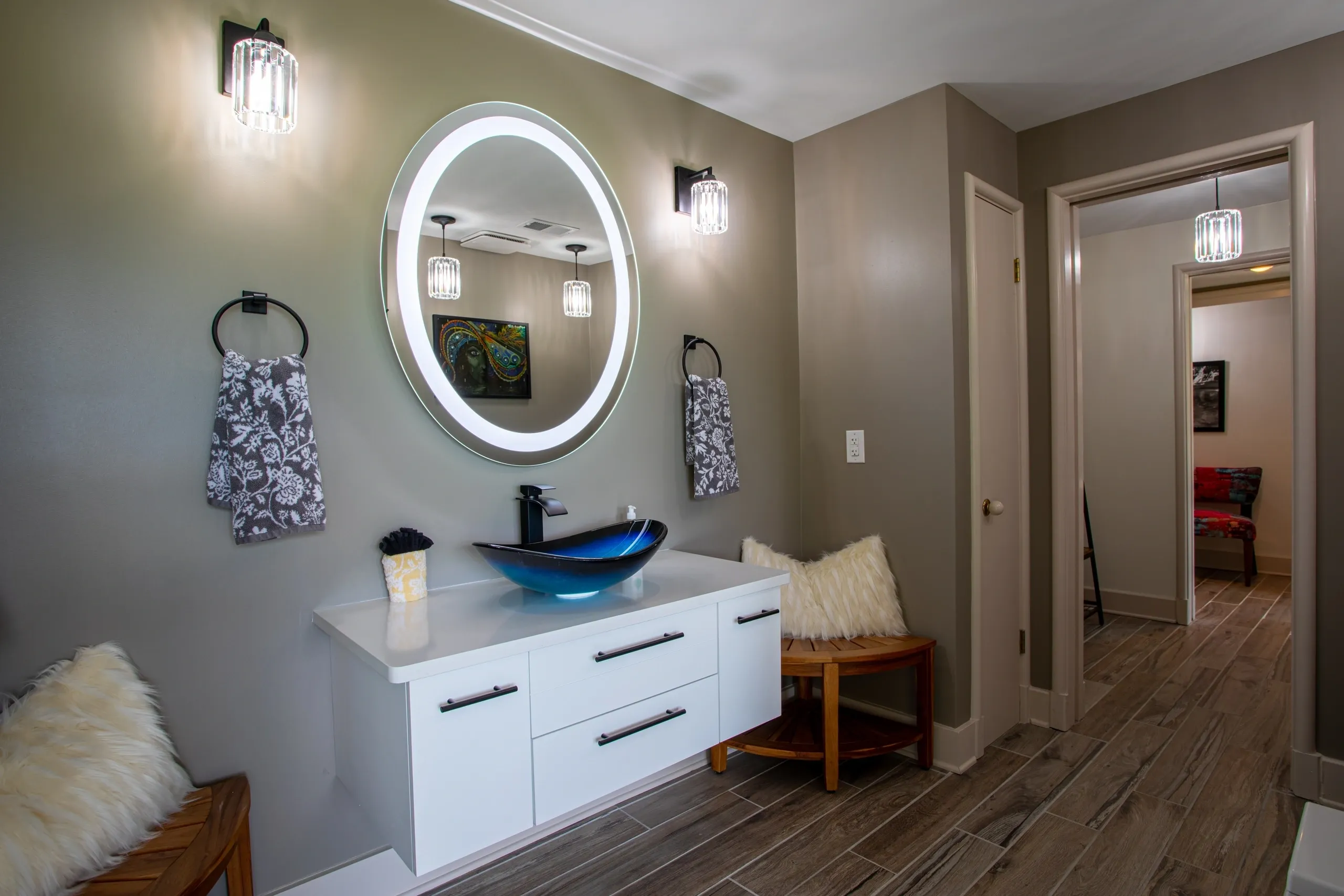 Modern bathroom with illuminated mirror and sink.