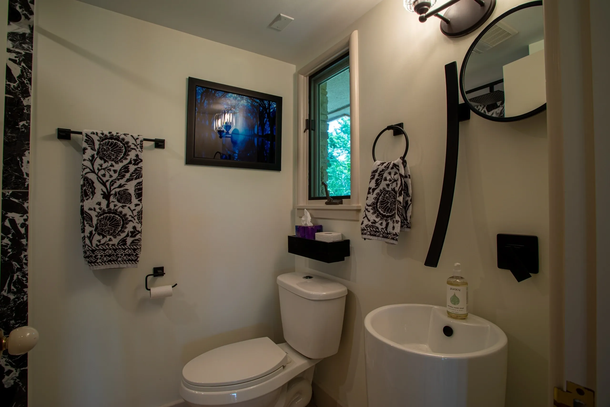 Small bathroom with black and white decor.