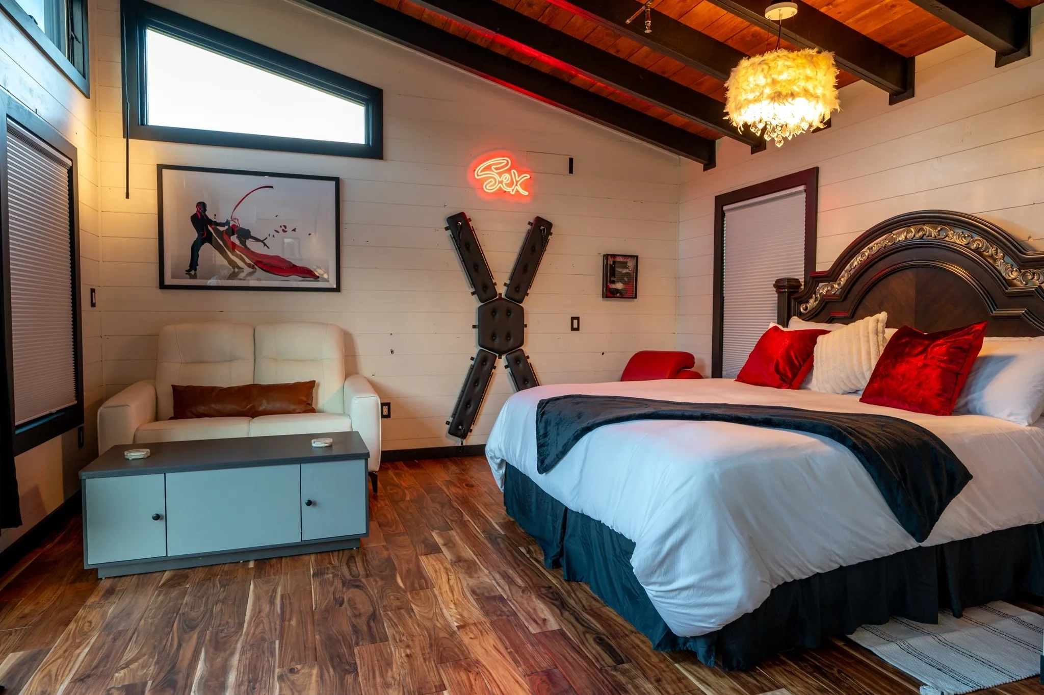 Rustic bedroom with modern decor and artwork.