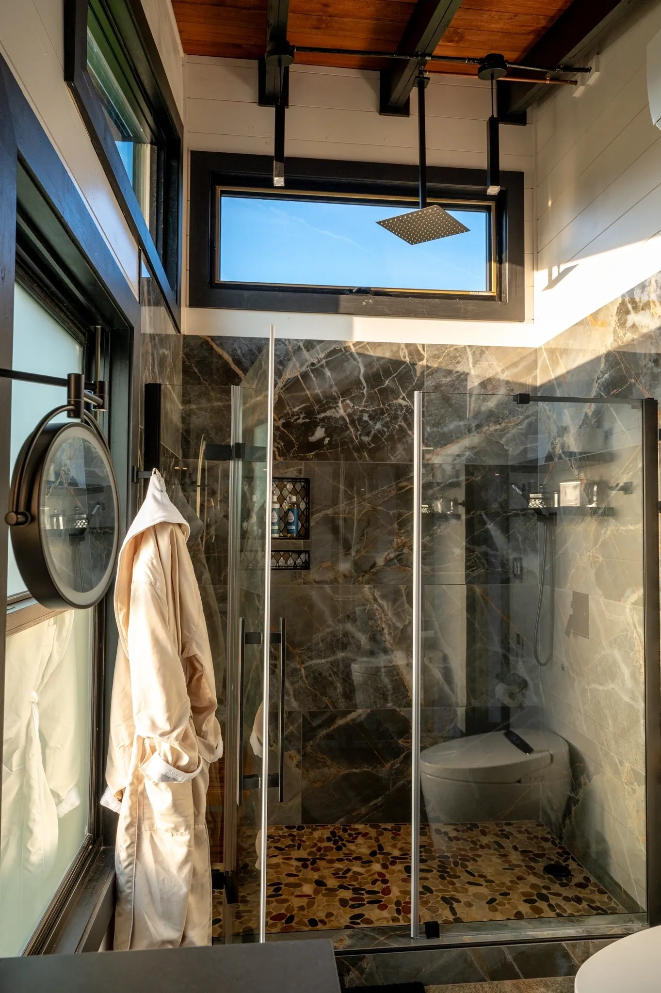 Modern bathroom with glass shower enclosure.