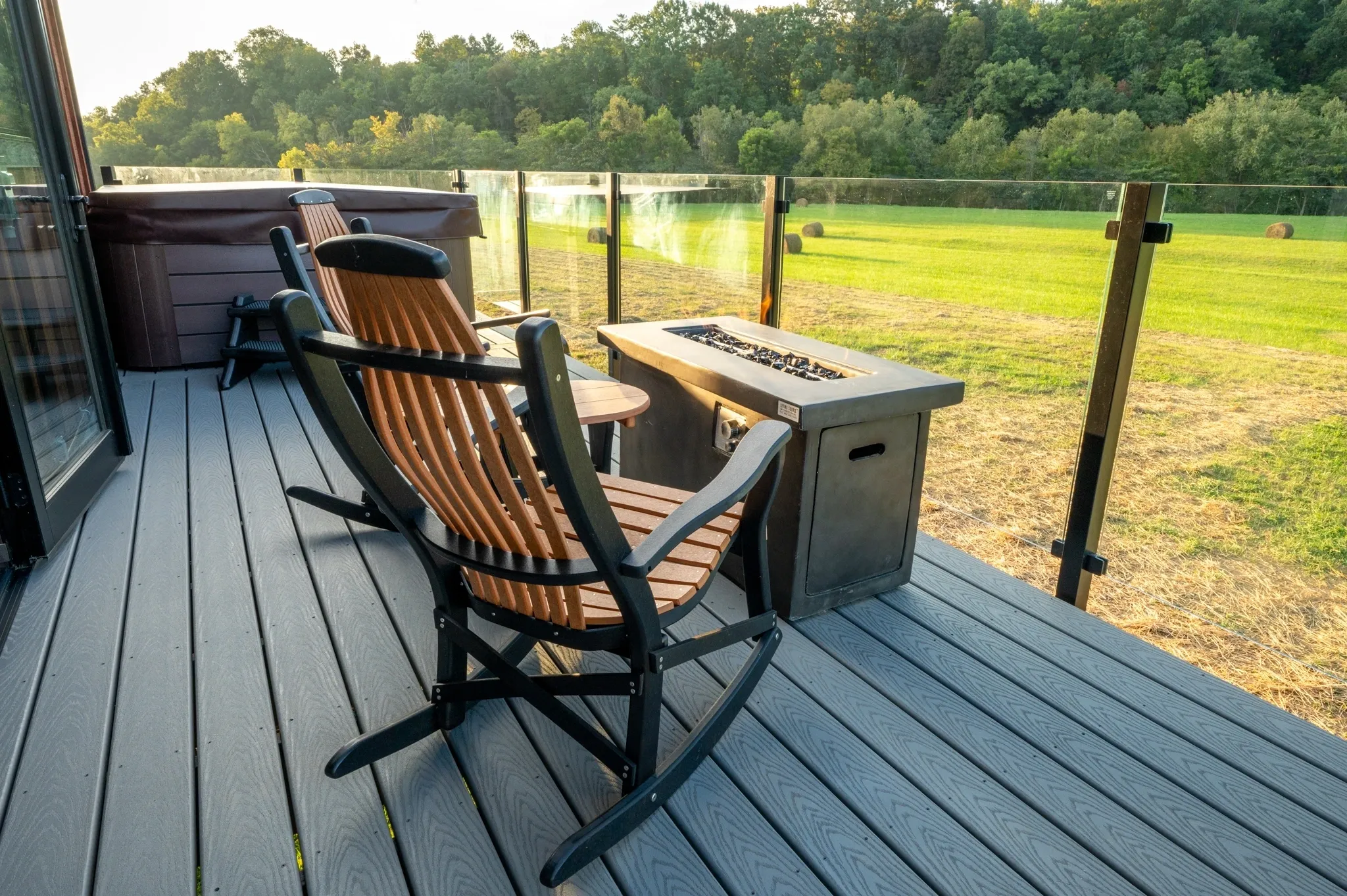 Deck with chairs and countryside view.