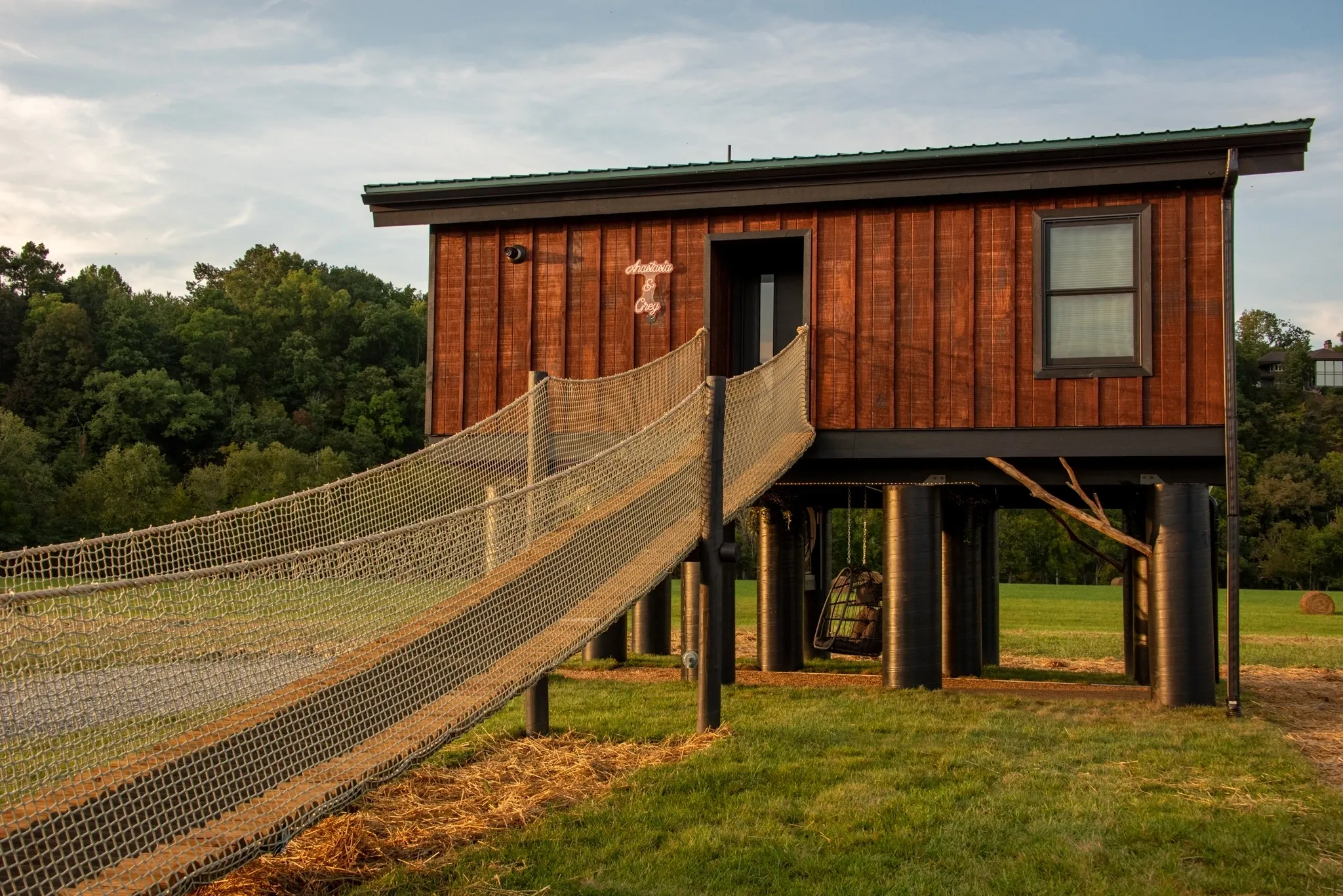 Elevated cabin with netted ramp access.