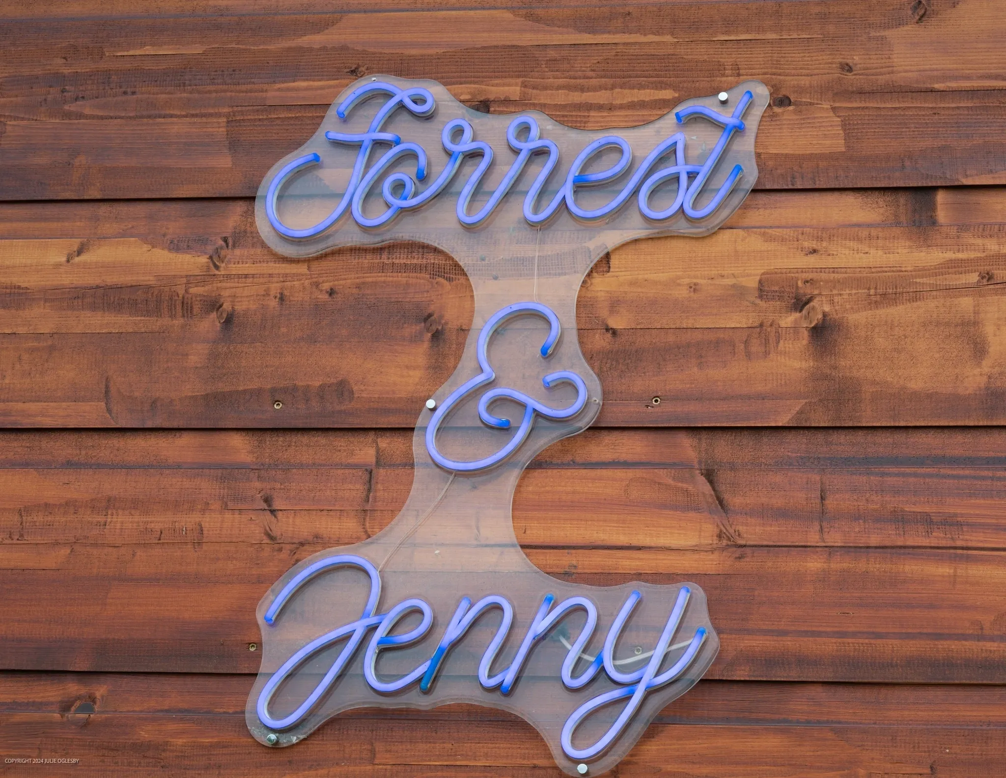 Neon sign with "Forrest & Jenny" text.