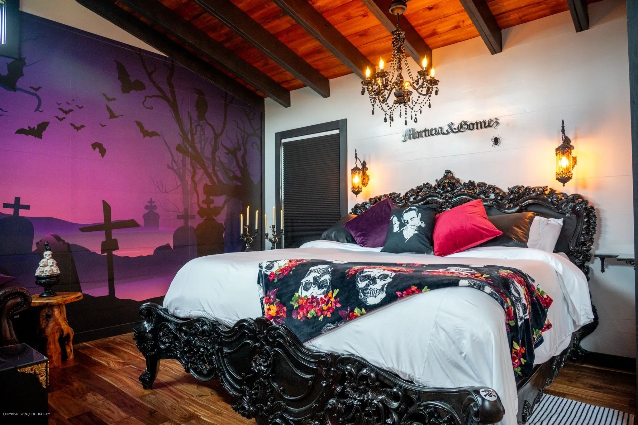 Gothic-themed bedroom with ornate black bed.