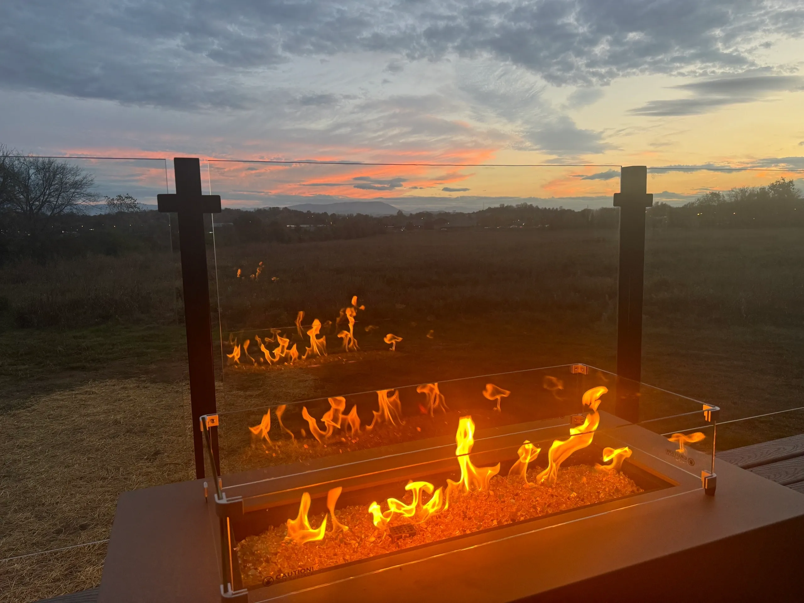 Fire pit glowing at sunset.