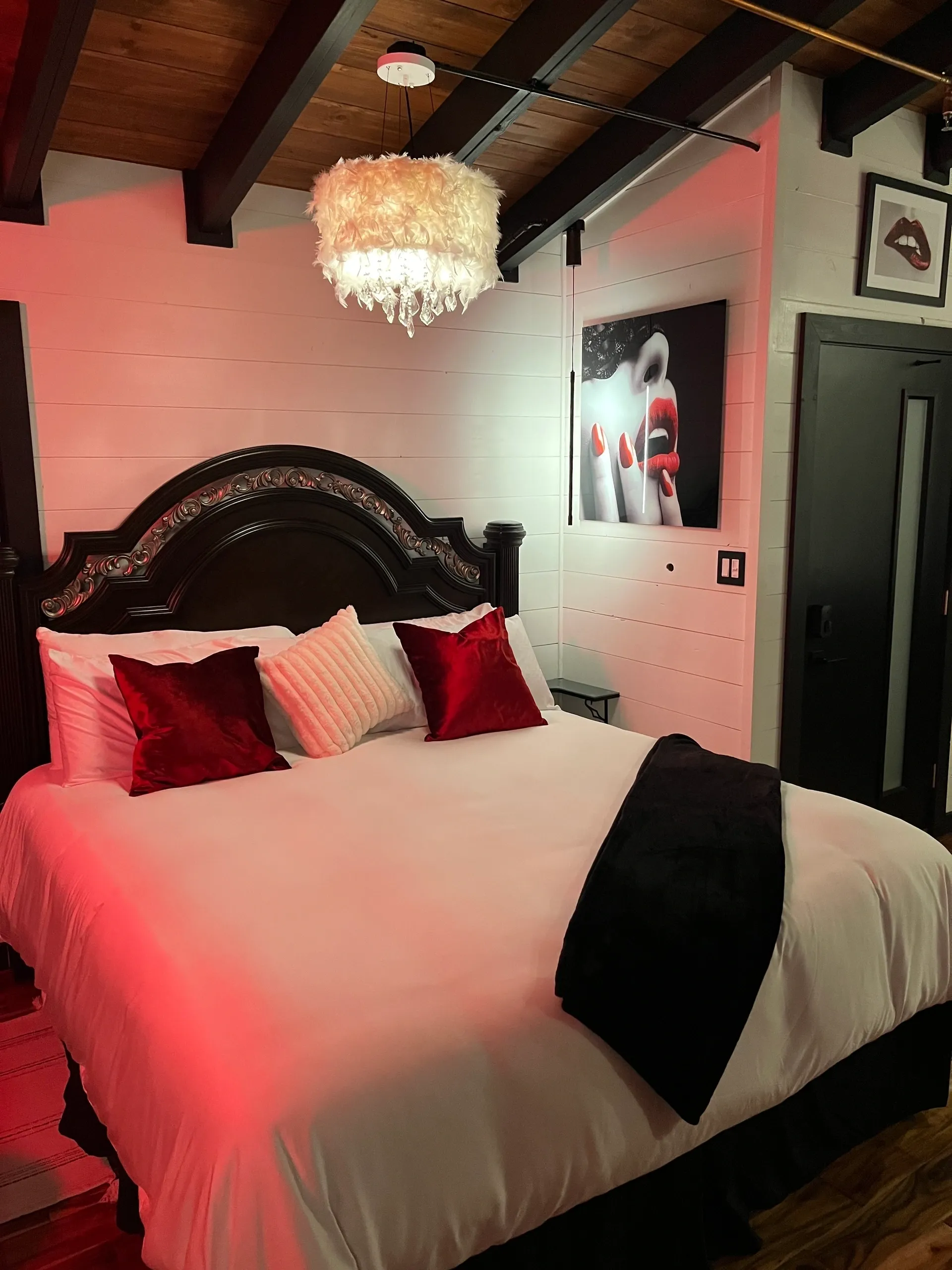 Cozy bedroom with red accent lighting.