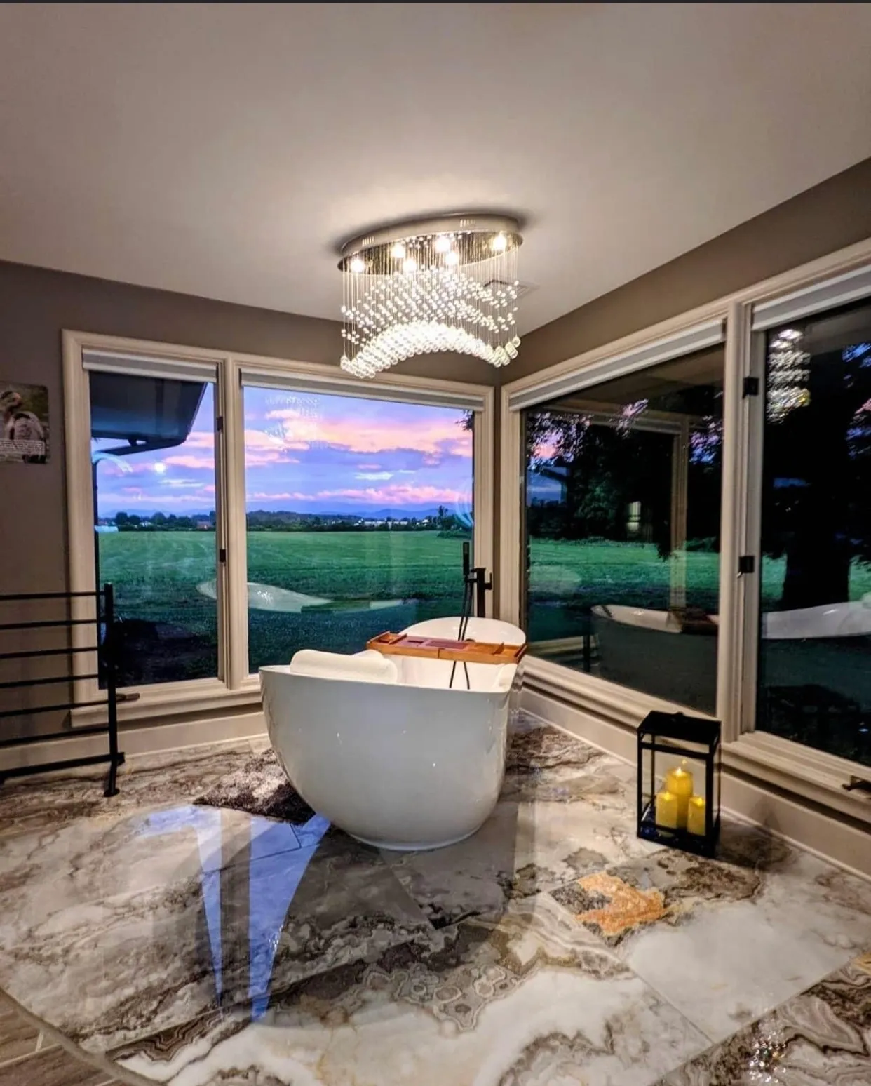 Luxurious bathroom with scenic sunset view.