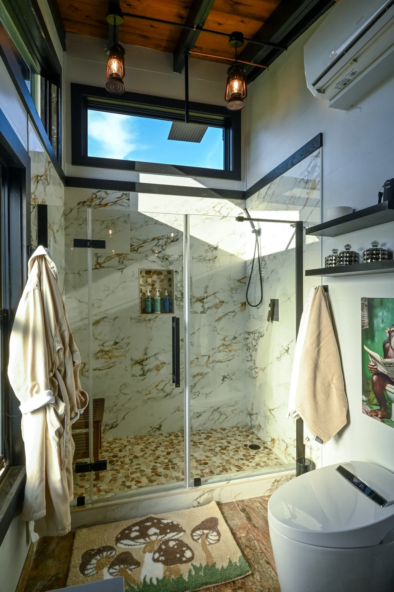 Modern bathroom with glass shower and decor.