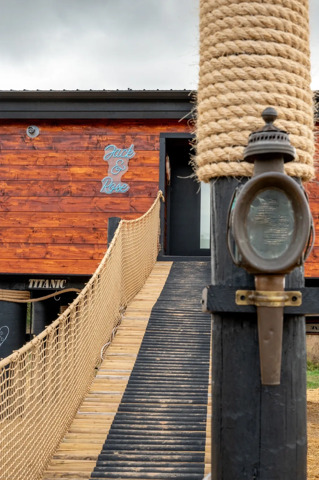 Wooden ramp leading to rustic building entrance.