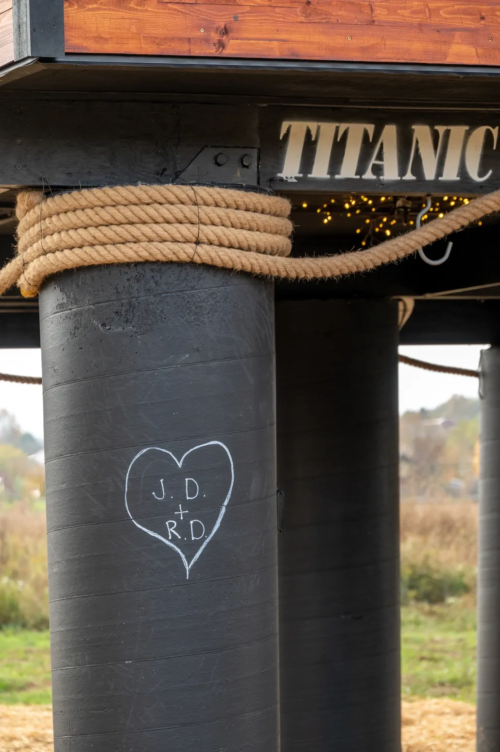 Heart engraving on black pillar, "Titanic" sign.