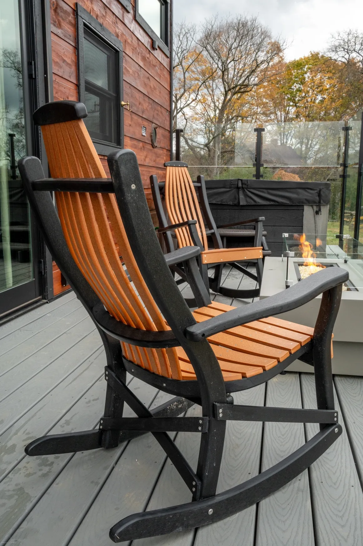 Rocking chairs on a modern outdoor deck.
